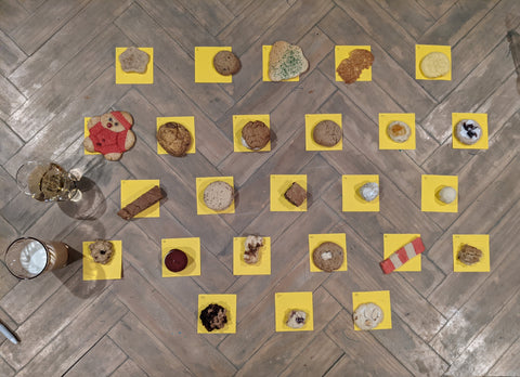 Table of 25 cookies on yellow post-it notes