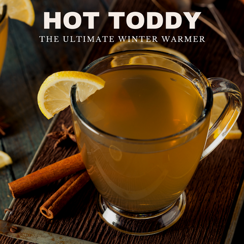 Steaming Hot Toddy in a glass on a table.