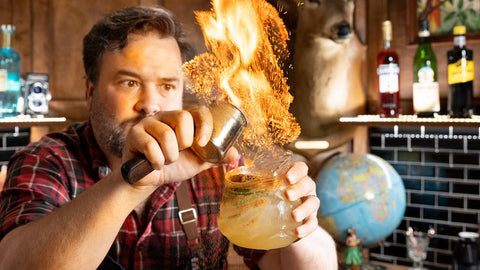 Man from How to Drink YouTube show setting a cocktail on fire