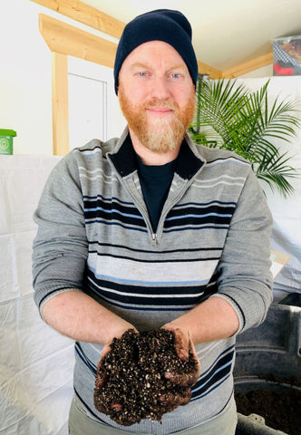 Michel Duteau holds soil