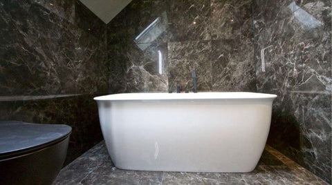 Black marble bathroom with freestanding bath