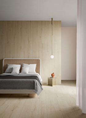 Light coloured Wood Effect tiles on floor and wall of bedroom