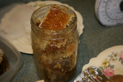 Mason jar filled with comb and honey 