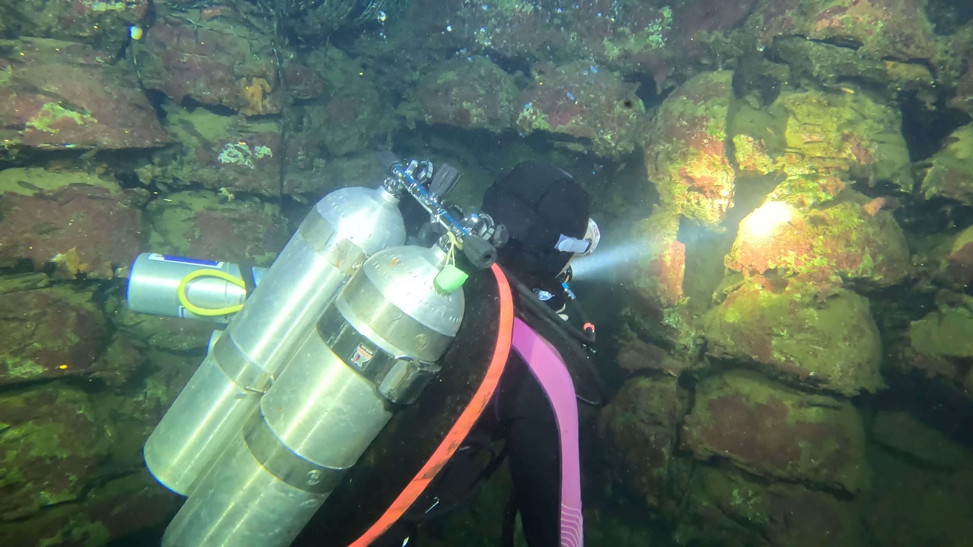 Diver In Front Of Some Rocks Underwater