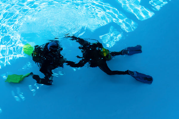 diver training with an instructor in a pool