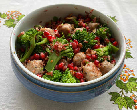 red rice with pork, pomegranate and broccoli