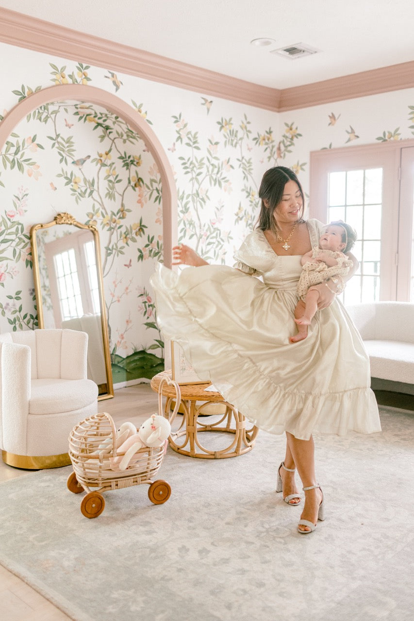 Blogger Joy Green and her new baby in a nursery decorated in Diane Hill's 'Chinoiserie Chic' wallpaper for Rebel Walls