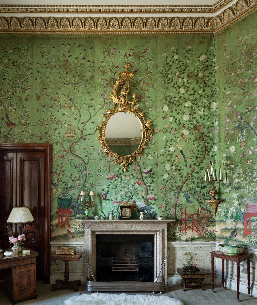 green chinoiserie wallpaper inside Belvoir Castle with brown antique furniture throughout