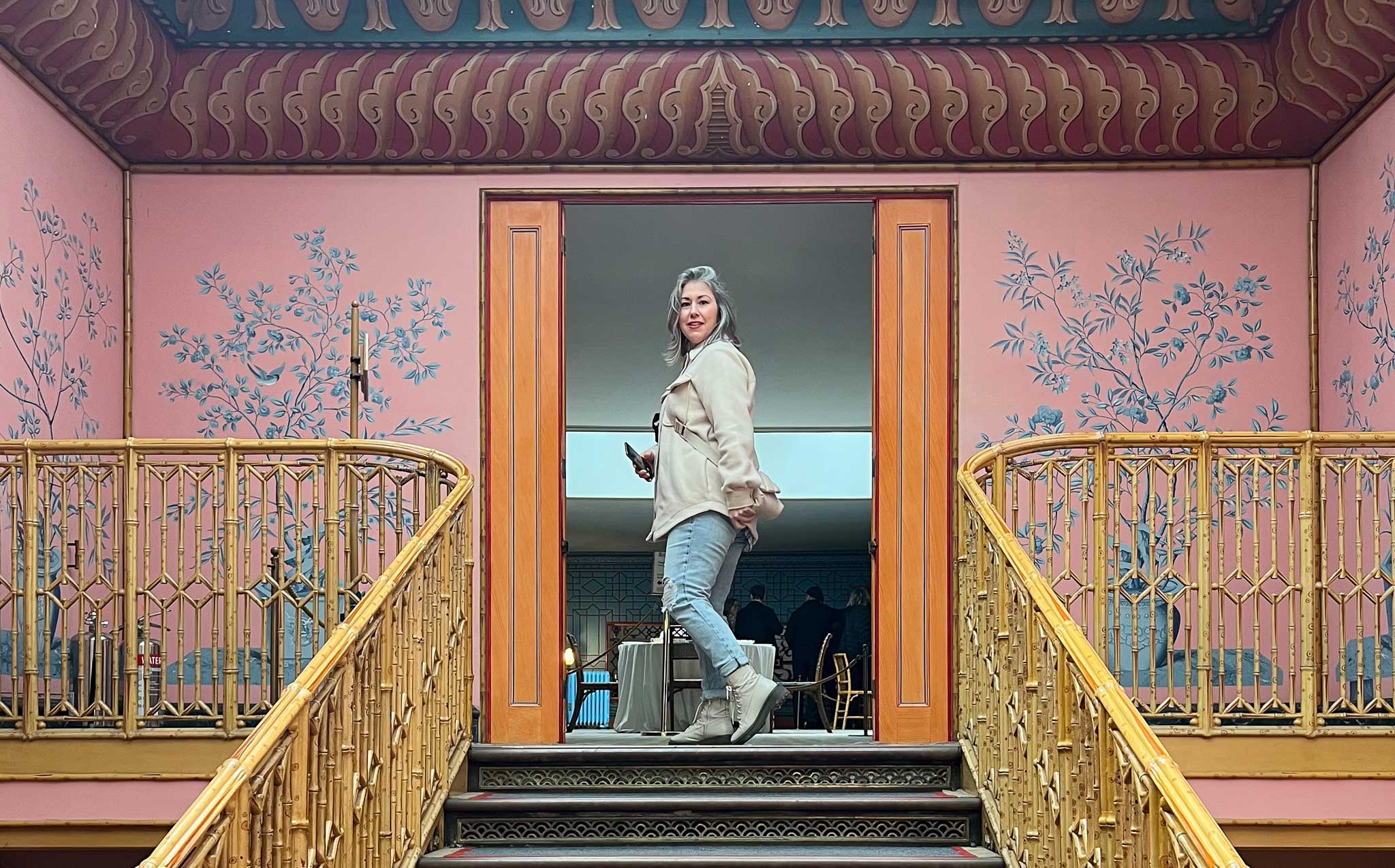 Artist Joanna Charlotte at the top of the grand staircase at Brighton Pavilion