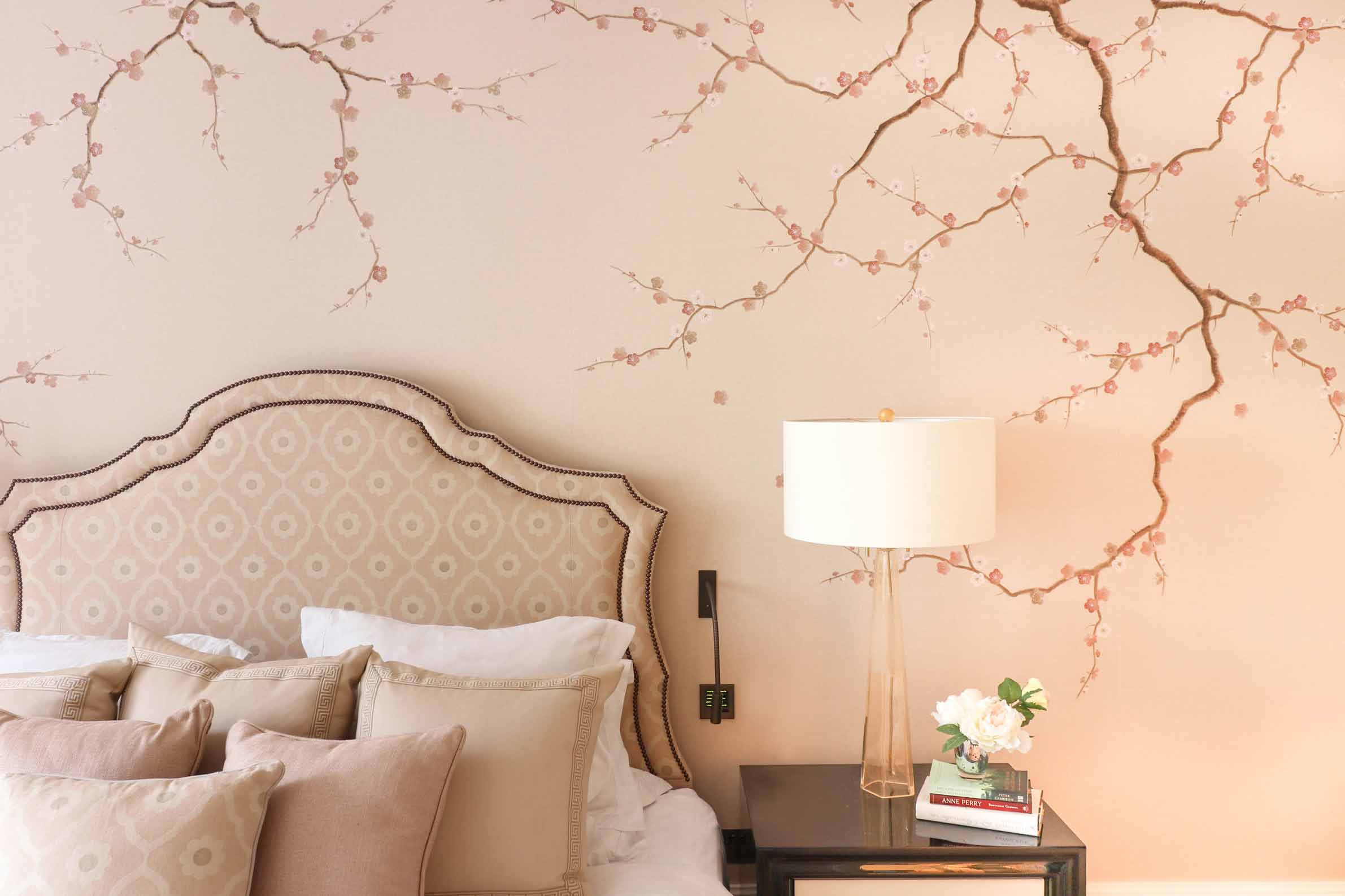 Photograph of a chinoiserie blossom flower mural wall painted by Diane Hill in a neutral toned bedroom