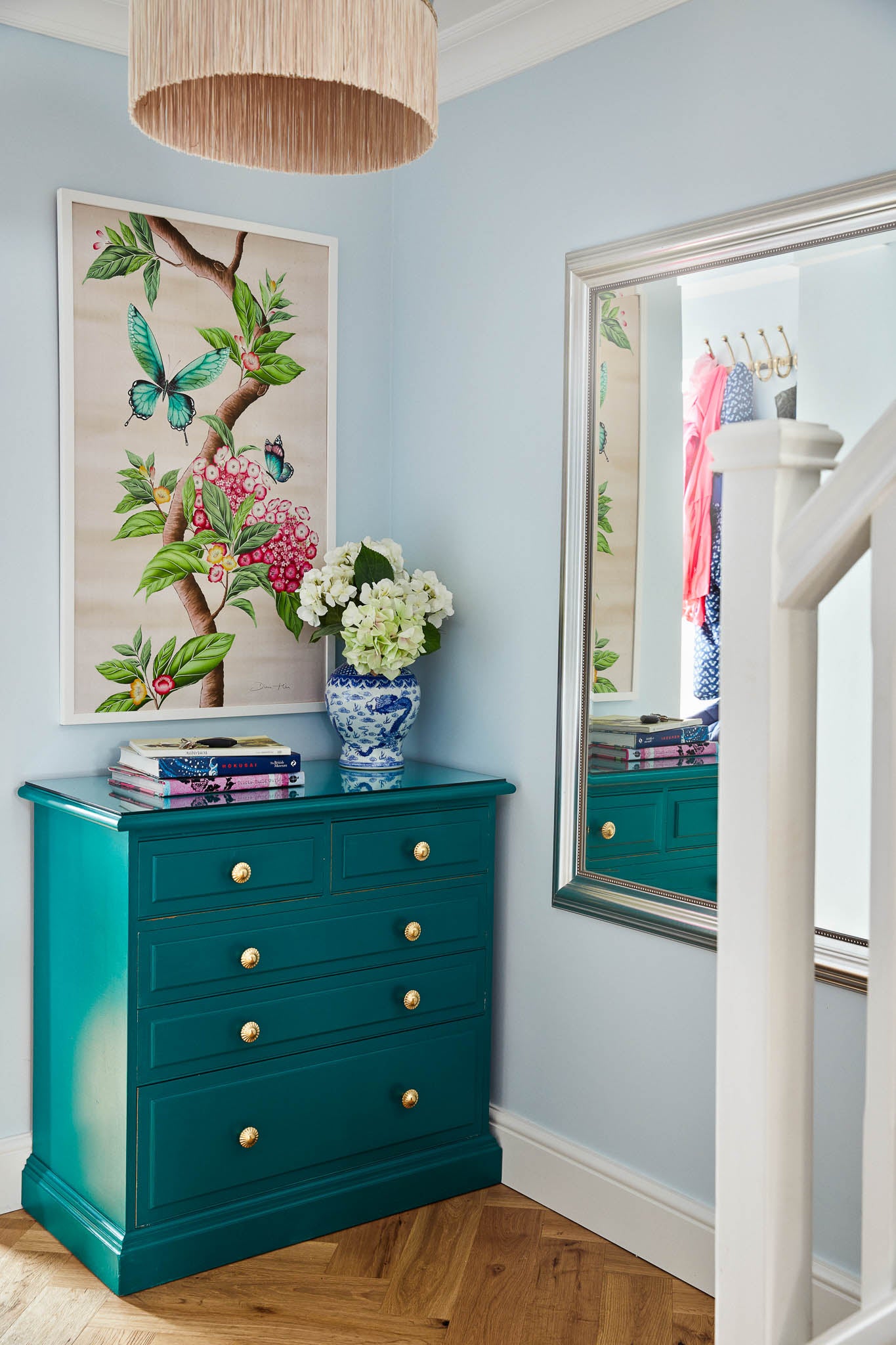 pink botanical chinoiserie art panel in bright modern hallway