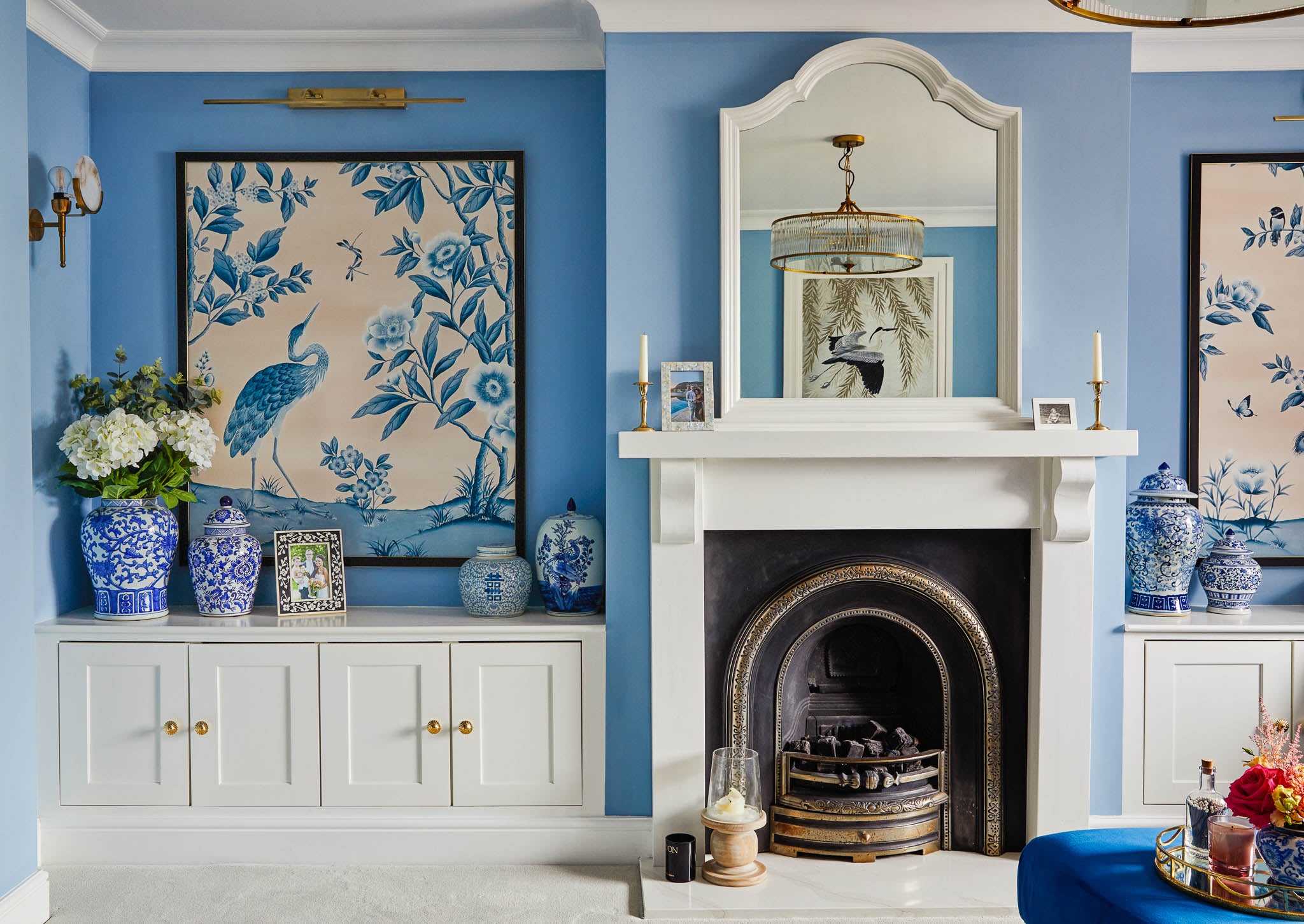 Blue and pink framed chinoiserie wallpaper panels in luxurious blue chinoiserie living
