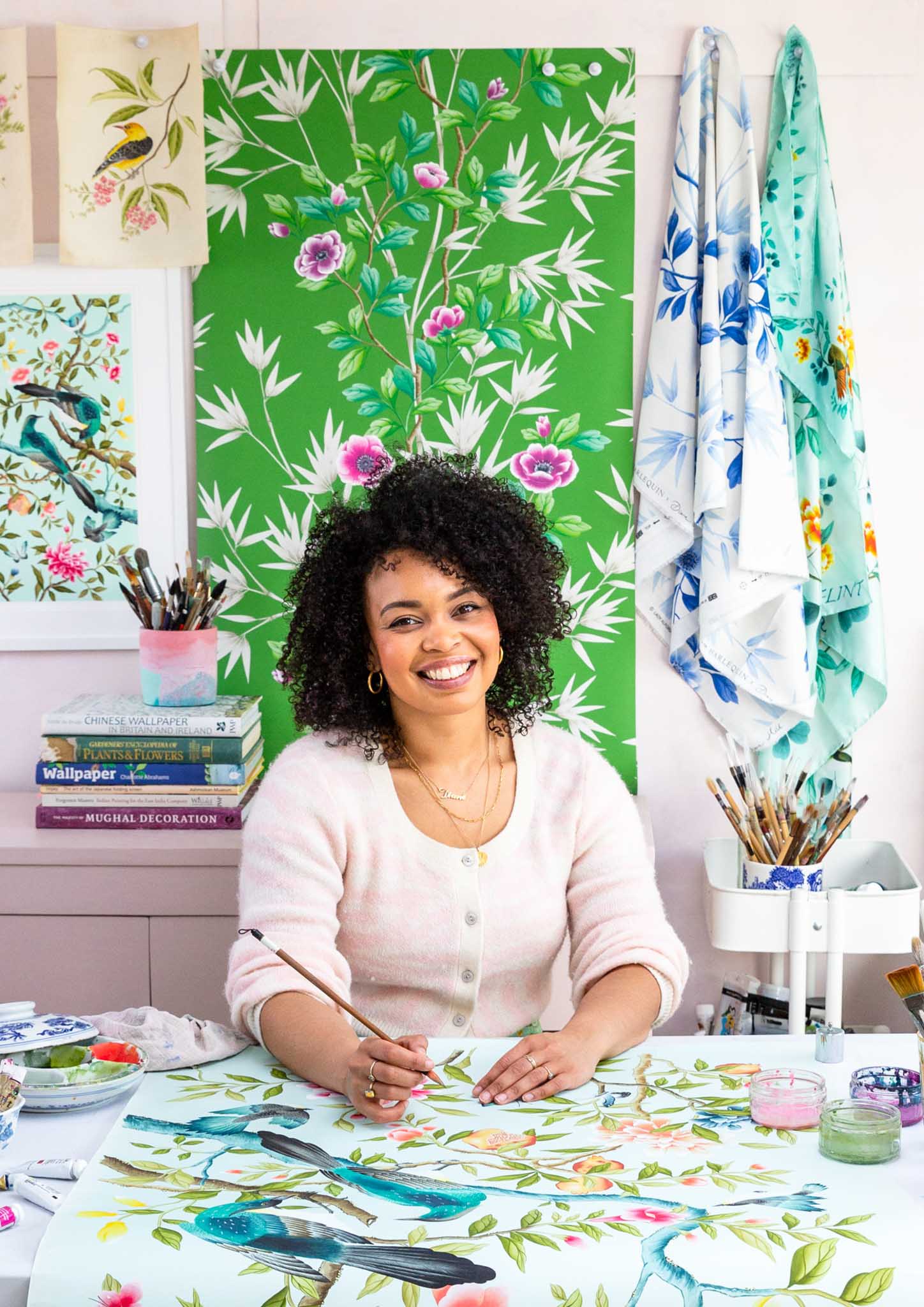 chinoiserie artist diane hill in her watercolour gouache art design studio surrounded by bright colour vintage botanical floral chinoiserie home decor wallpaper designs