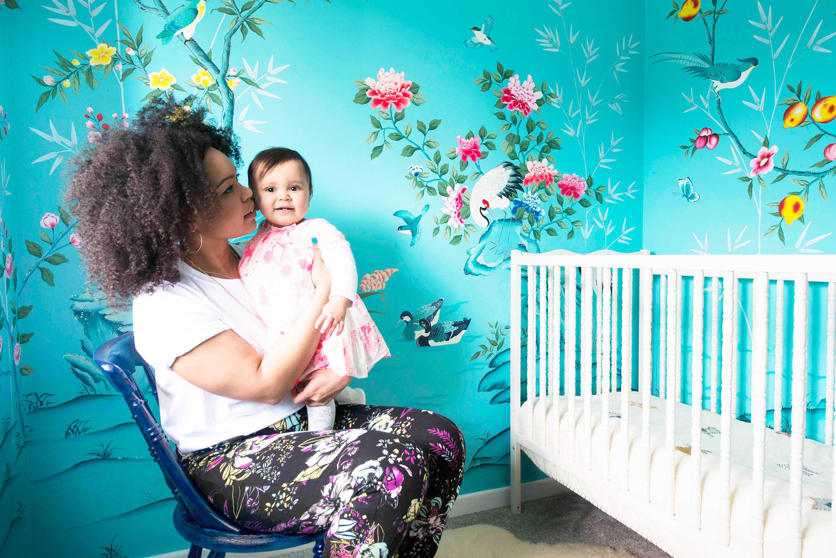 Chinoiserie artist Diane Hill and her child in colourful nursery with Chinese wallpaper inspired hand-painted Chinoiserie wall mural