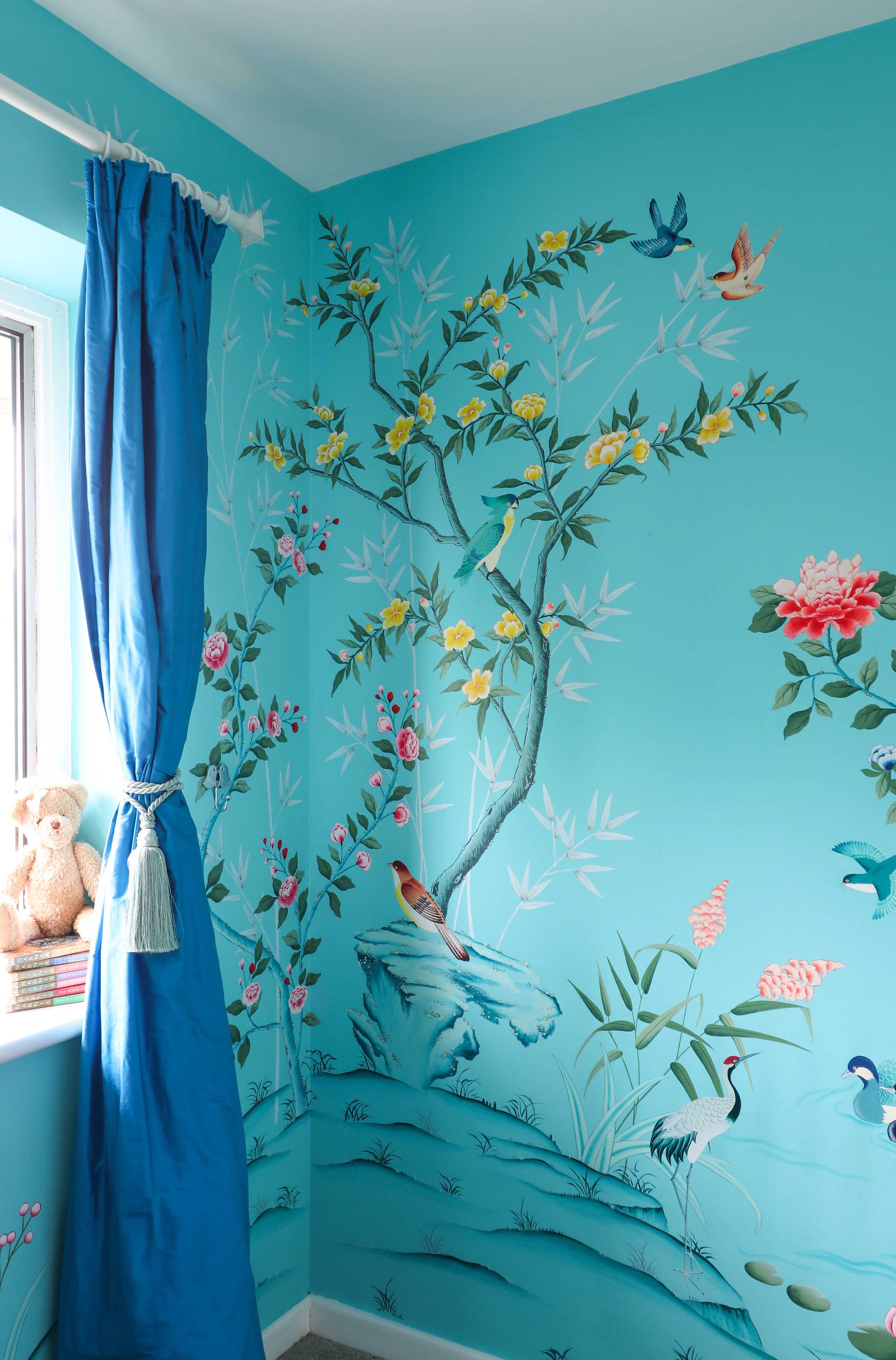 blue hand painted chinoiserie wall mural in childrens nursery