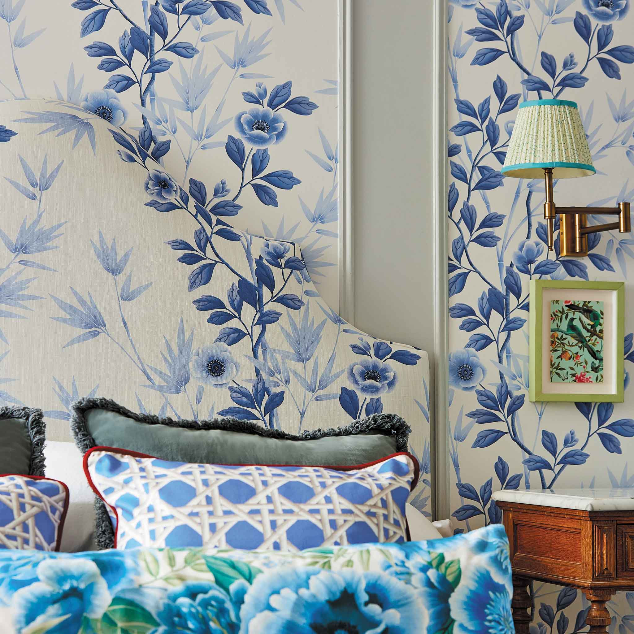 Lifestyle photo of blue and white chinoiserie bedroom featuring fabrics and wallpaper by diane hill