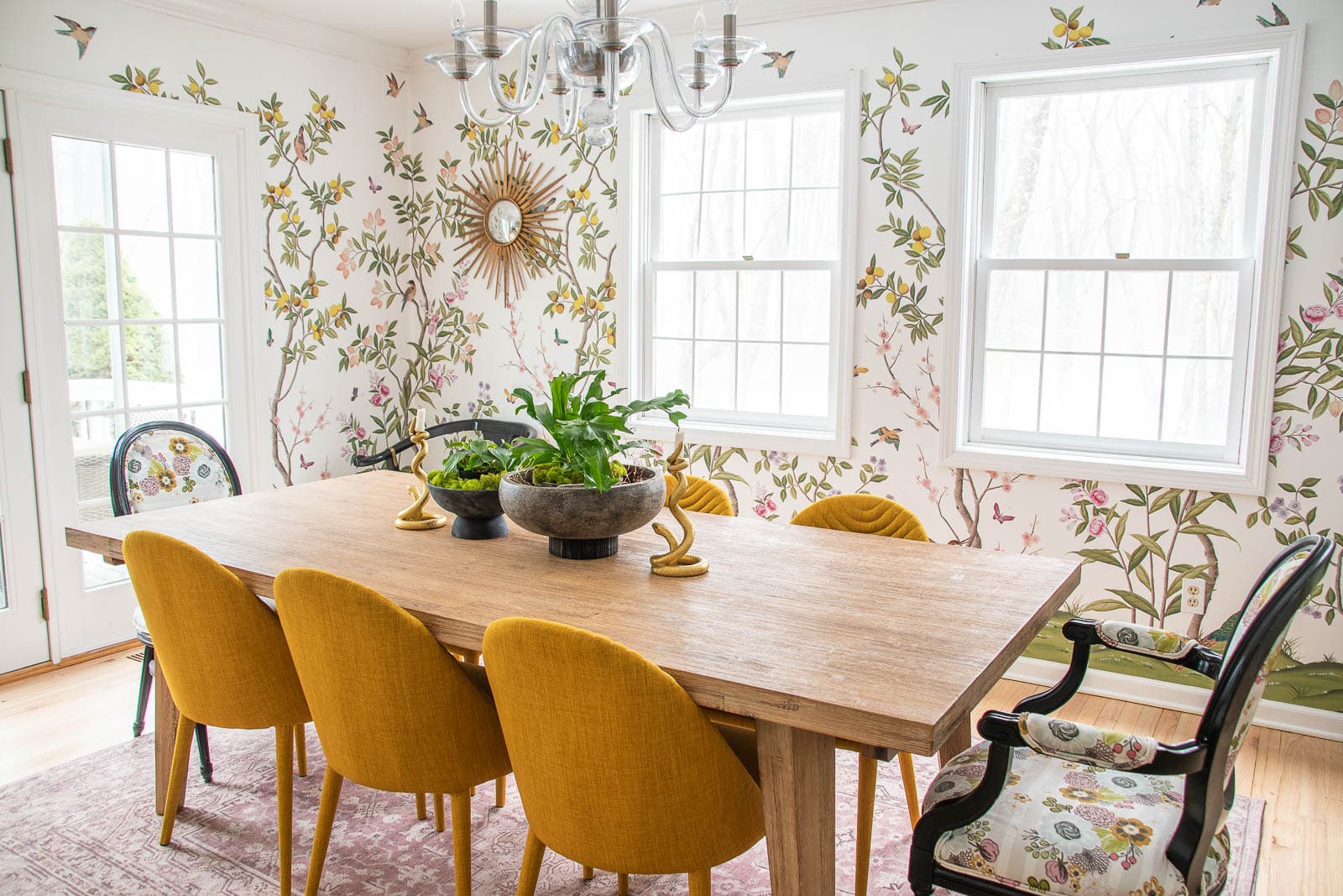 'Chinoiserie Chic' wallpaper by Diane Hill for rebel walls in the dining room of blogger 'At Charlotte's House' featuring large rectangle dining table with 8 mix and match dining chairs