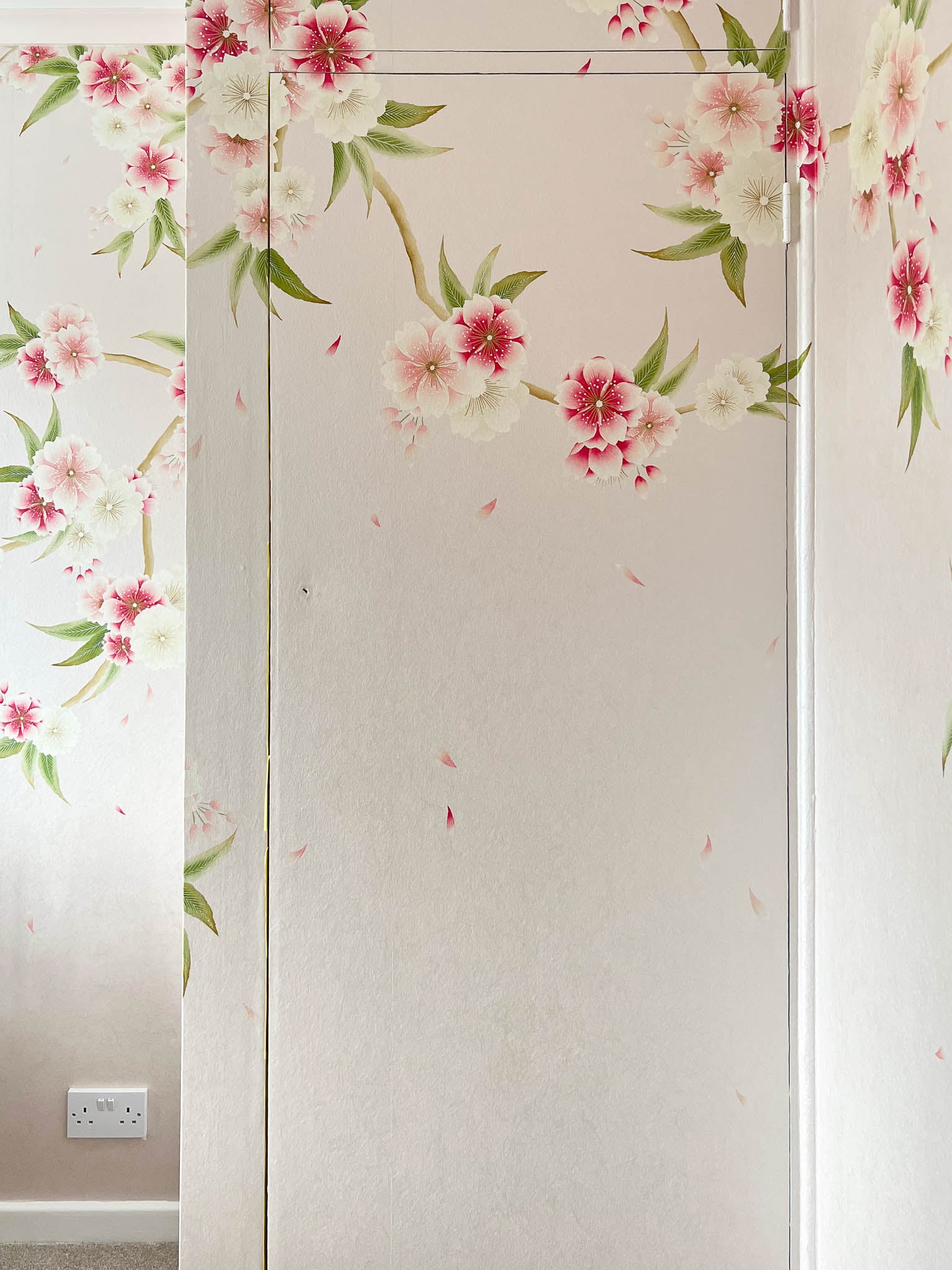 Cupboard covered by Diane Hill's 'Rosa' chinoiserie wallpaper