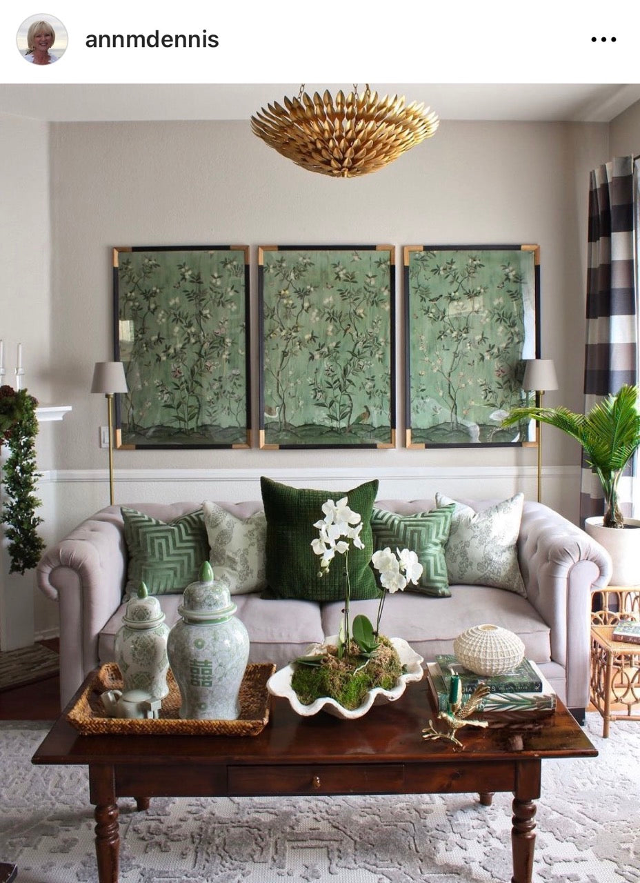 Instagram screen shot of living room featuring Diane Hill's 'Chinoiserie Chic, Jade' wallpaper for Rebel Walls as three chinoiserie wall art panels