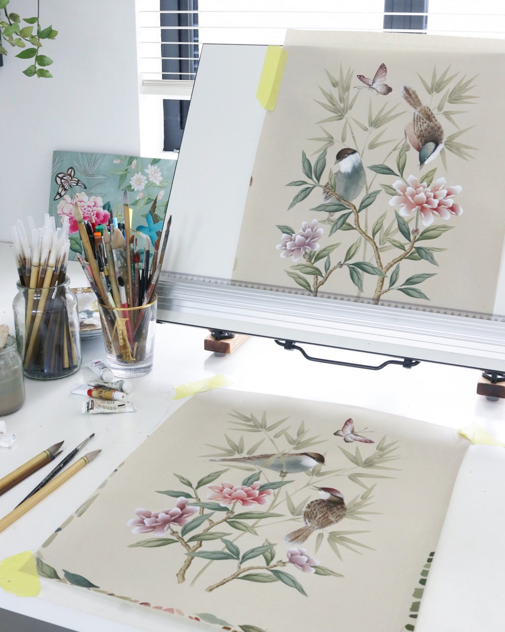 Diane Hill's botanical nature art chinoiserie paintings in her art studio with Chinese paintbrushes and watercolor gouache paints