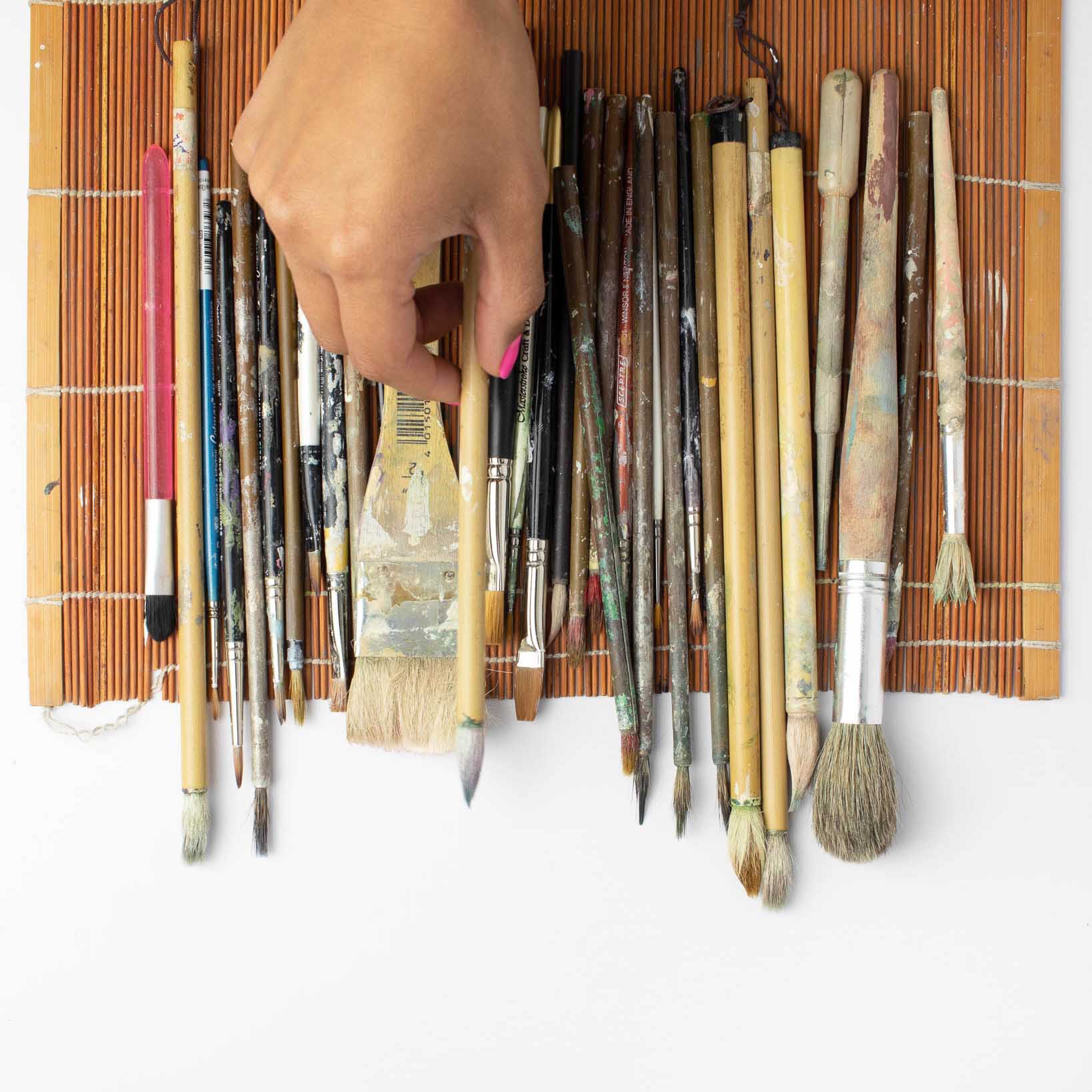 Chinese paintbrushes in a rollable chinoiserie paintbrush holder