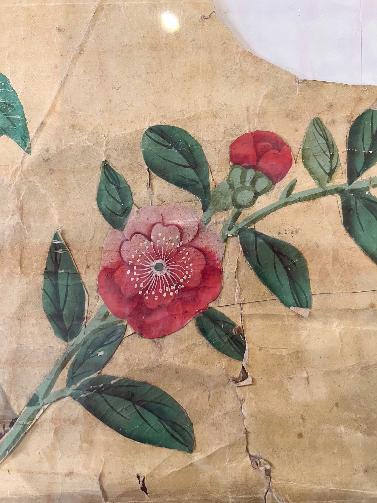 Fragment of chinoiserie wallpaper featuring a red flower from Queen Victoria's bedroom at Brighton Pavilion