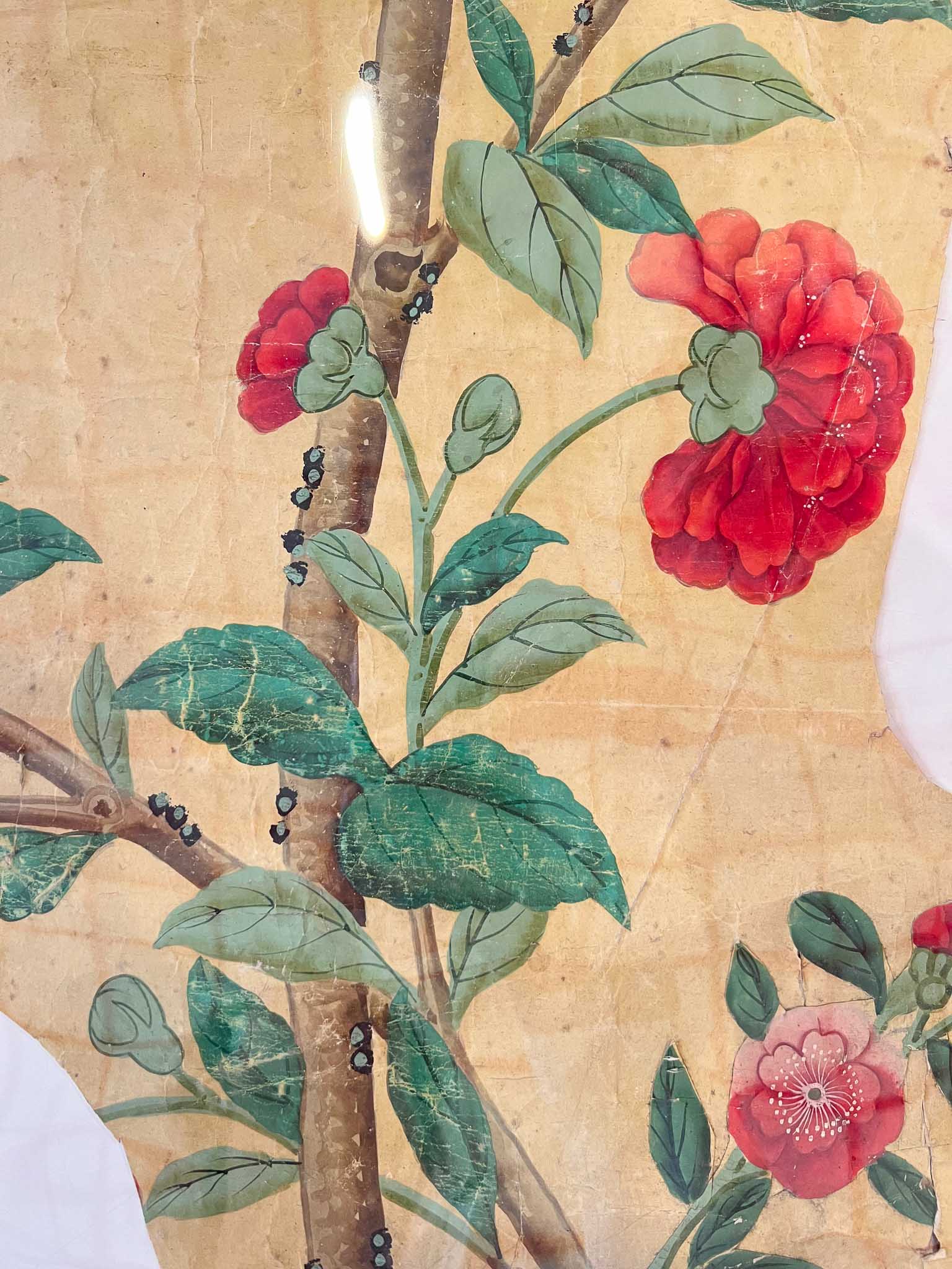 Panel of chinoiserie wallpaper with red flowers and green leaves from Queen Victoria's original bedroom at Brighton Pavilion