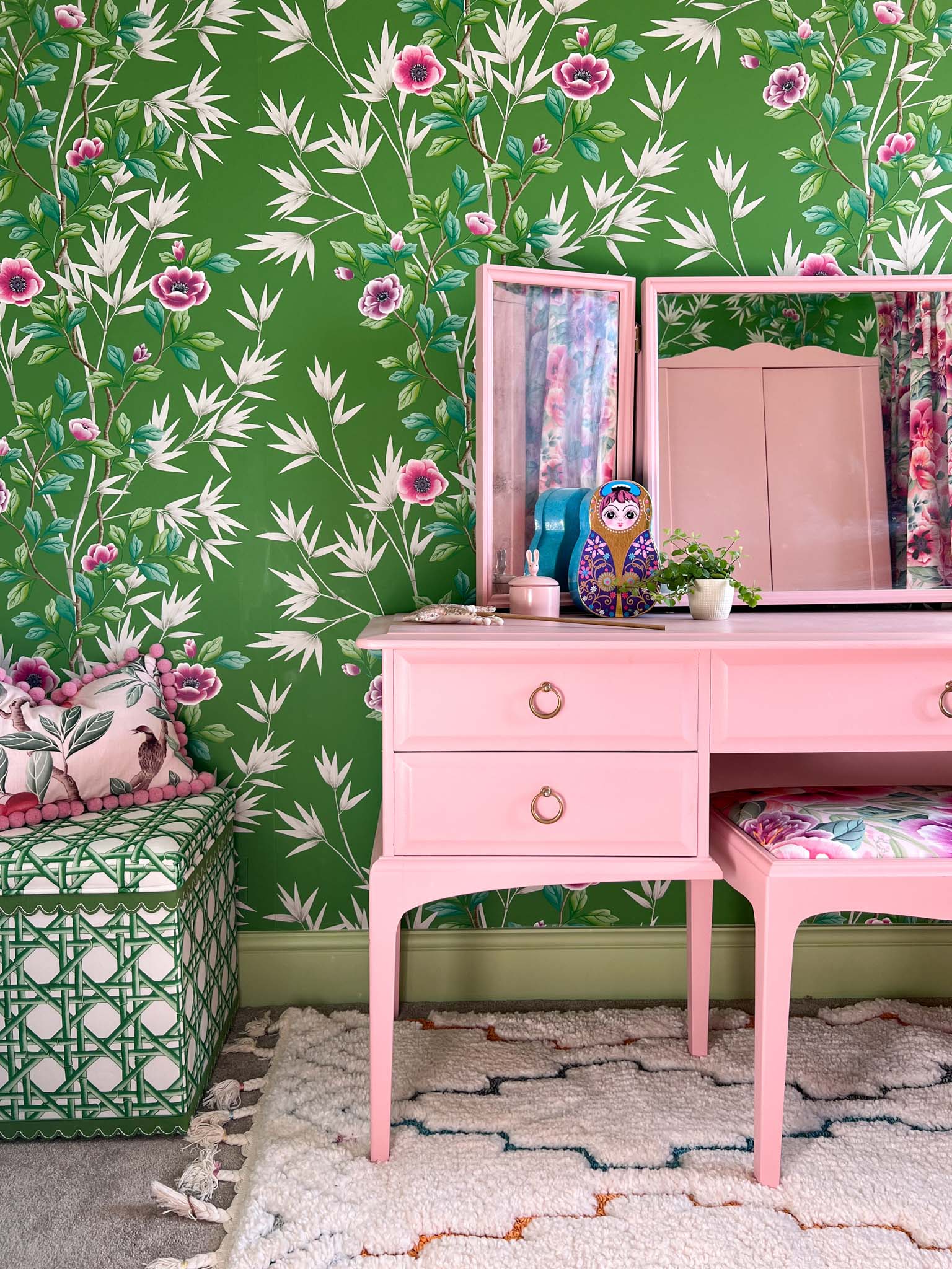 pink and green maximalist child's bedroom featuring green floral chinoiserie wallpaper and pink vintage furniture