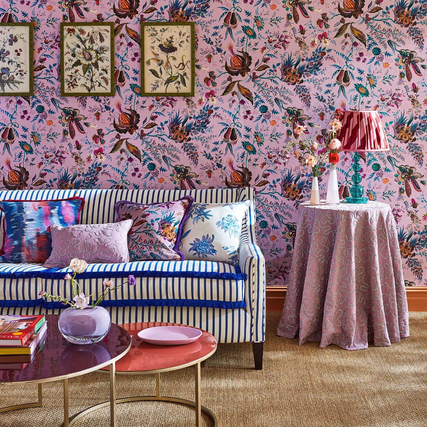 Pink maximalist style living room with floral wallpaper and a striped sofa designed by Sophie Robinson for Harlequin