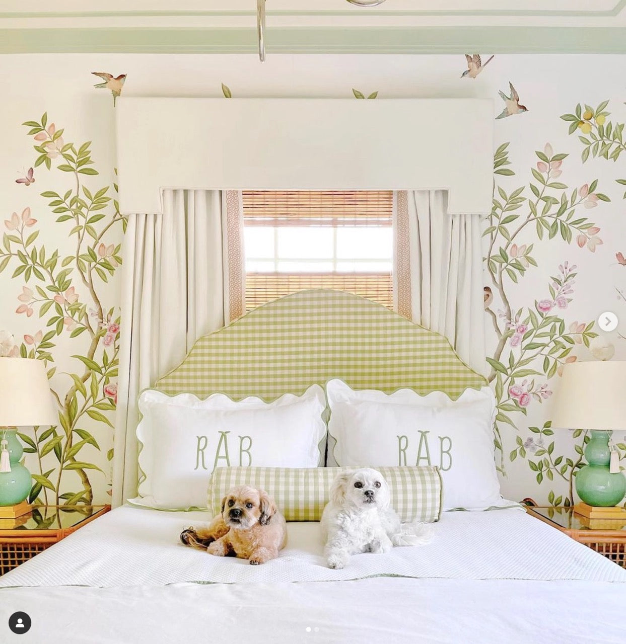 Grandmillennial style bedroom featuring Diane Hill's 'Chinoiserie Chic' wallpaper for Rebel Walls and a white bed with two dogs
