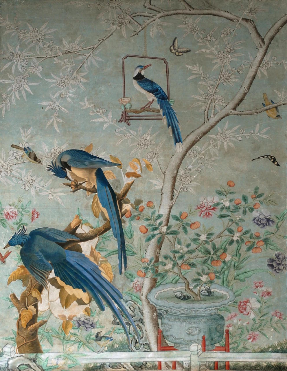 Chinoiserie wallpaper with blue painted bird cut outs used over the top
