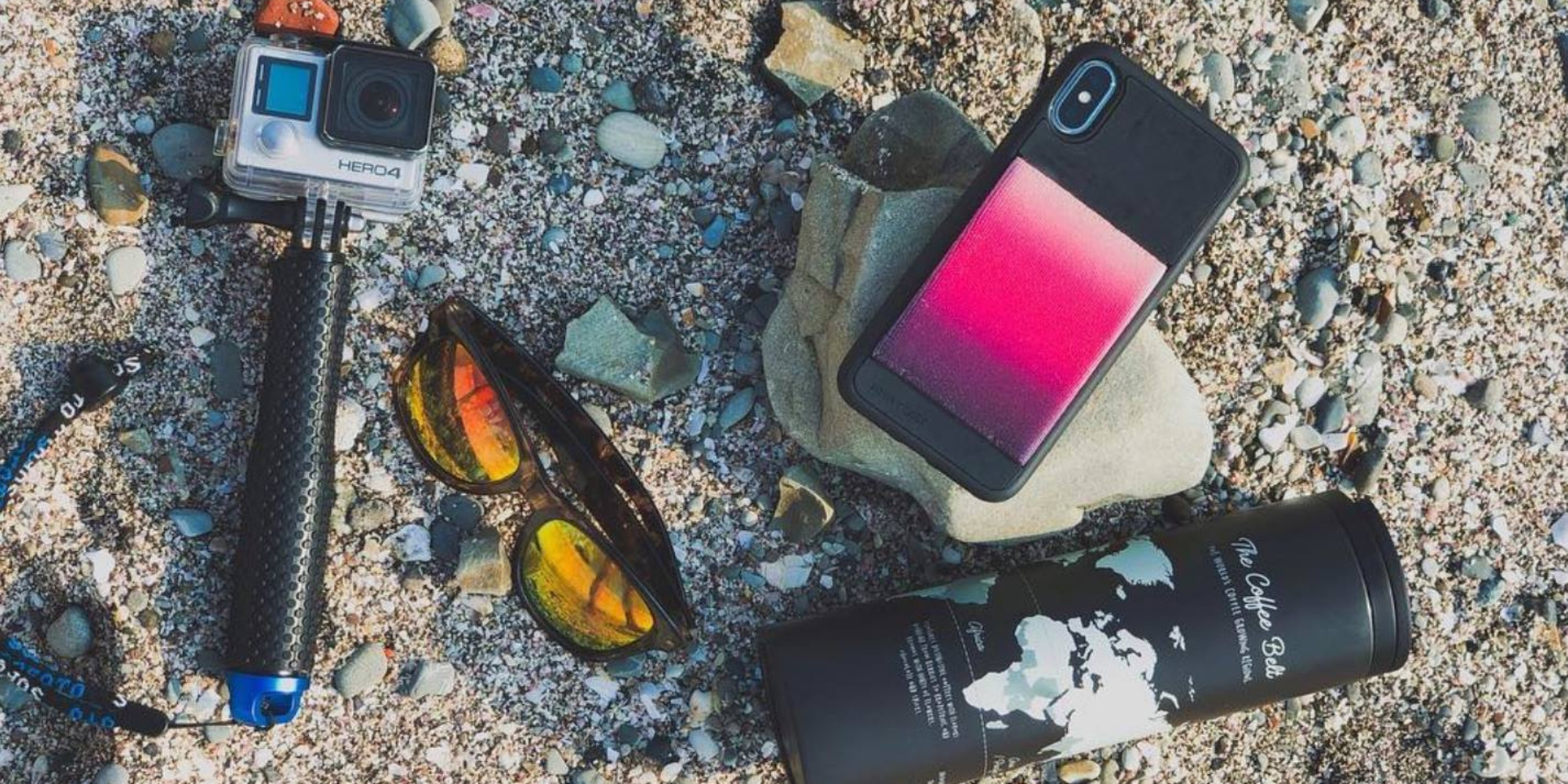 phone and accessories on the sand