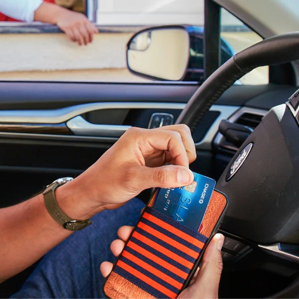 Man pulling a credit card out of his wallet case