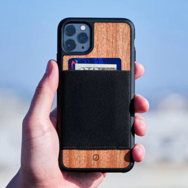 Hand gripping the wood wallet case