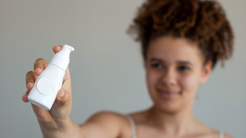 Woman holding Green Tea Gel Cream Bottle