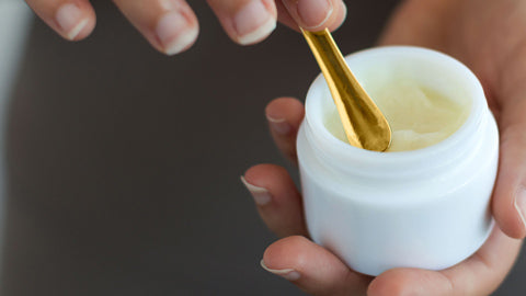 Image of All-Over Oild Balm being scooped with little gold spoon