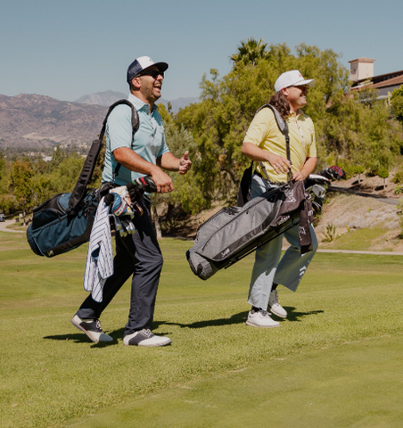 two guys walking with their golf bags