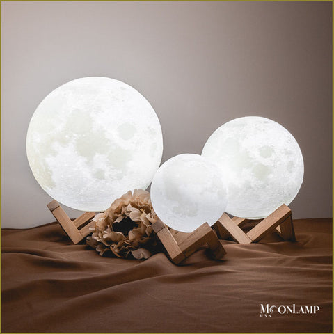 Three Moon Lamps of different sizes on the table