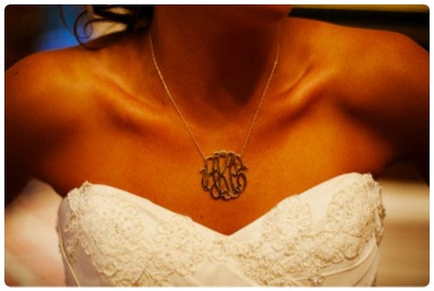 bride wearing gold monogram necklace