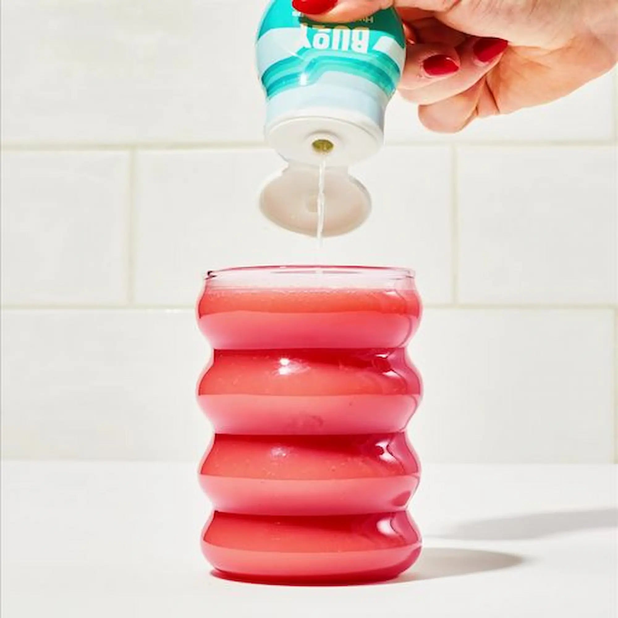 Squeezing Buoy hydration drops into a smoothie.