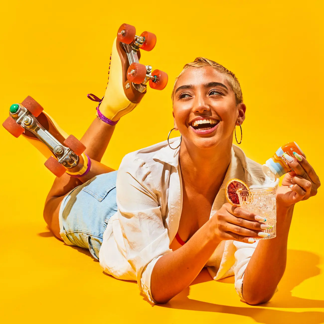 Woman with roller blades on pouring Buoy drops into a beverage.