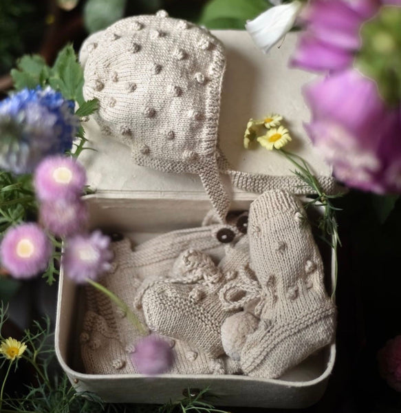 Heirloom baby clothes in a storage box