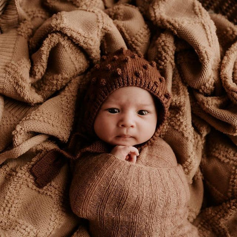 baby in popcorn brown bonnet