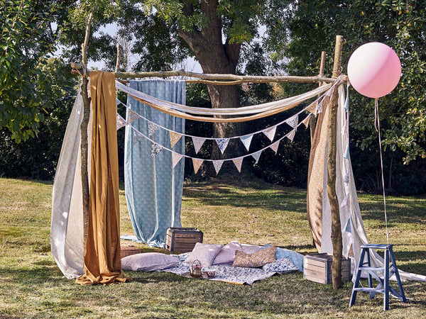 The perfect picnic setting made with Liberty fabric blankets, cushions and bunting.