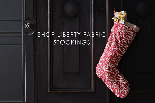 Liberty print fabric stocking by Coco & Wolf hanging up on Christmas Eve.
