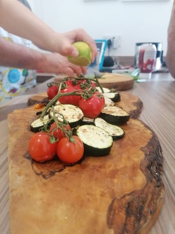 Close up tomatoes and chopped vegetables on a chopping board