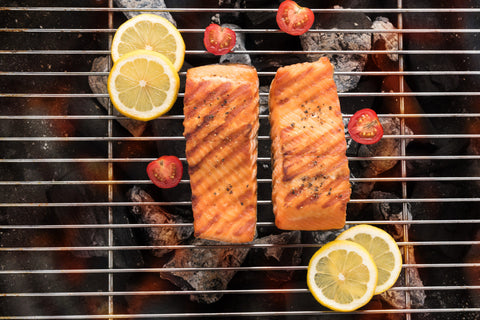 Cooked Salmon with lemon slices on a grill
