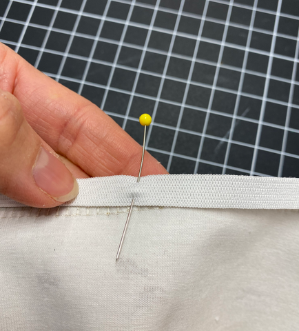 Pin the elastic to the outer side of the top seam allowance