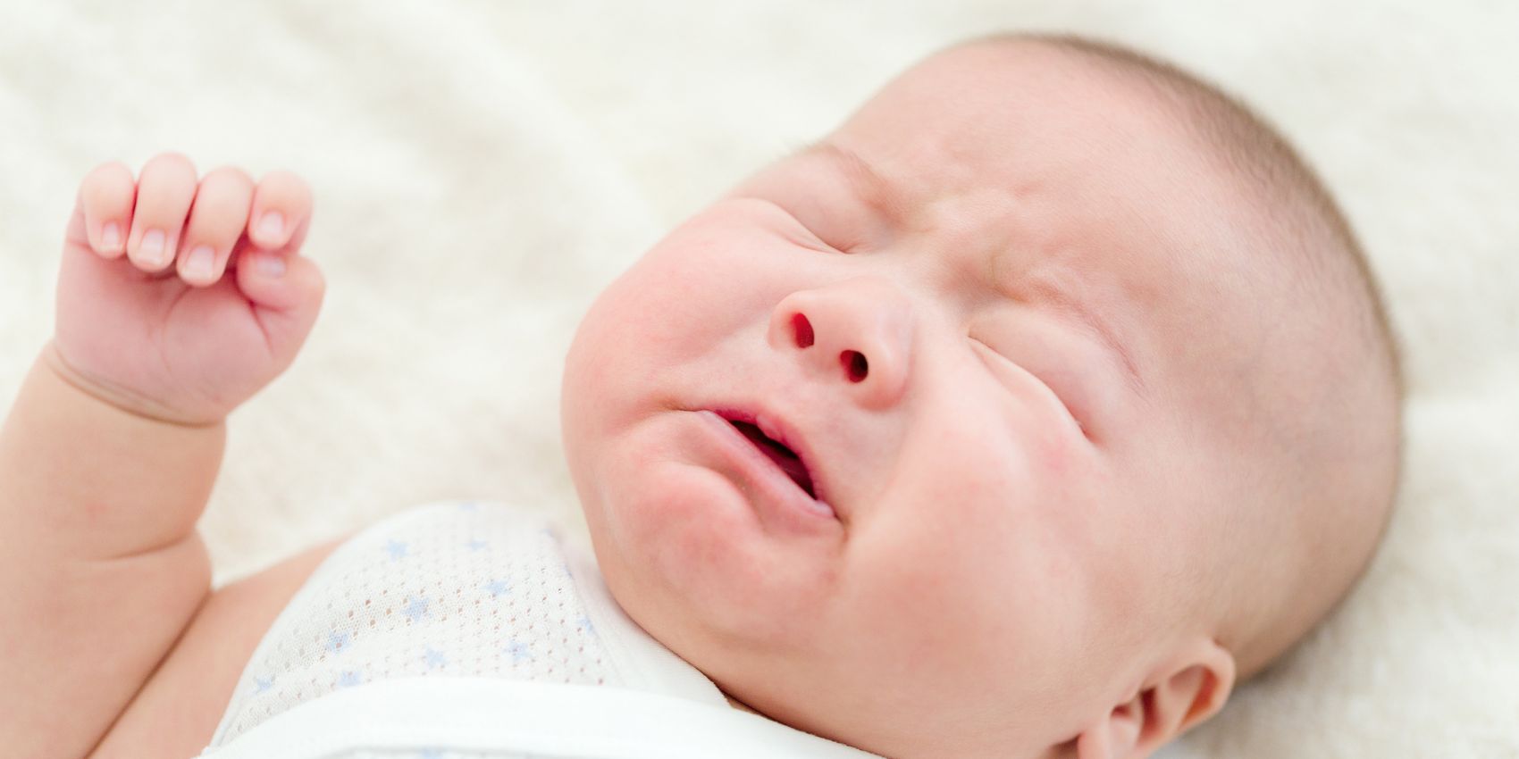 Newborn baby crying to express hunger