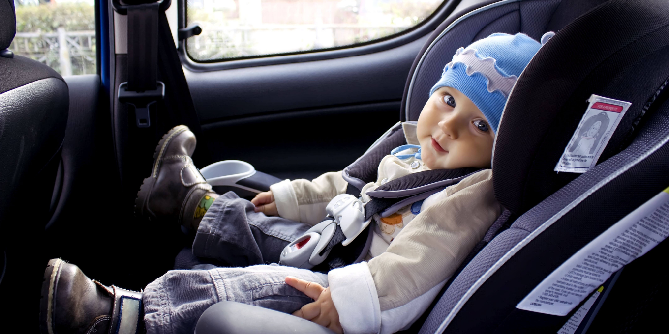 Baby boy sitting in carseat while driving down the road